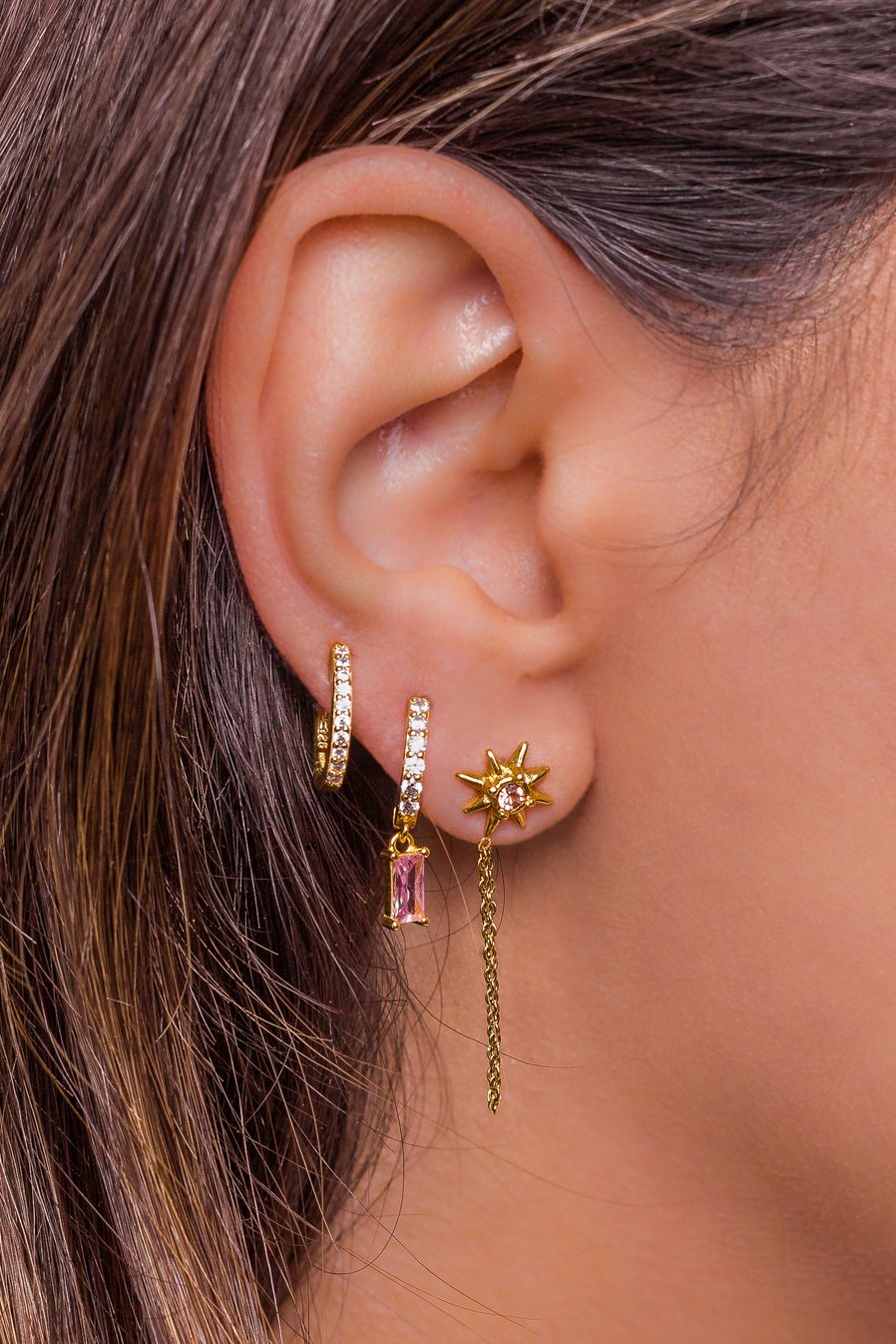 Woman Ear with Mulriple Piercings Wearing Beautiful Earrings Wit