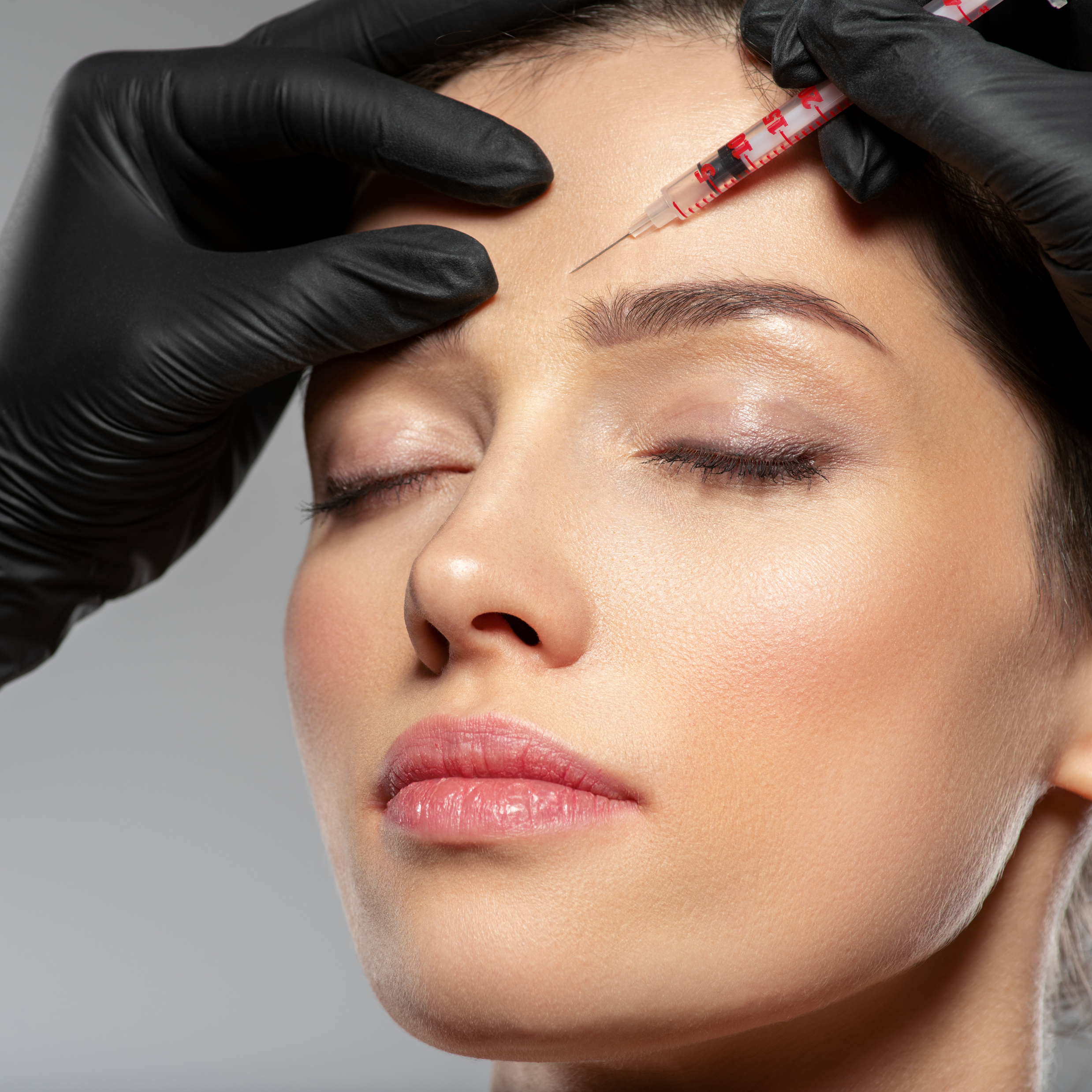 Caucasian Woman Getting Botox Cosmetic Injection in Forehead. Wo